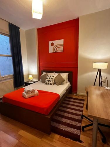 a bedroom with a bed with a red headboard at Apartment in Great Location in Kadıkoy Seaside w. Amazing Shared Terrace in Istanbul