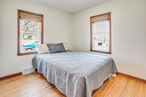 a bedroom with a bed and two windows at Pet-Friendly Sioux Falls House - 2 Mi to Downtown! in Sioux Falls