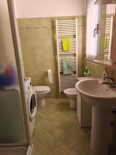 a bathroom with a sink and a toilet and a sink at Appartamento donatello in Imola