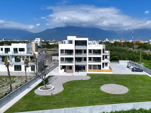 a large white building with a lawn in front of it at Anchorage Lodge in Jian