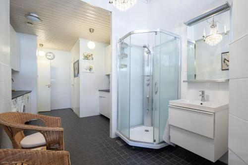 a bathroom with a shower and a sink at Lindallén Guest House in Fiskars