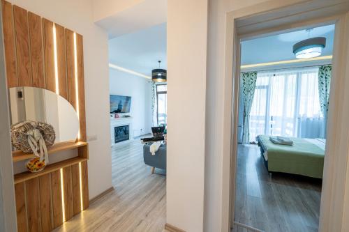 a room with a bed and a living room at Cross Caraiman View 2 in Buşteni