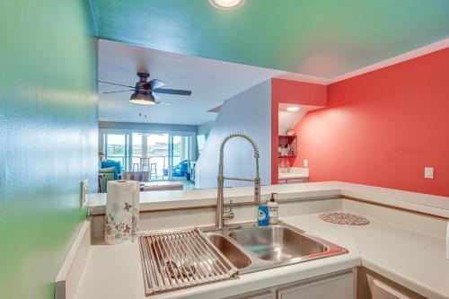 a kitchen with red and blue walls and a sink at Folly Beach Retreat with Pool Access and River Views! in Folly Beach