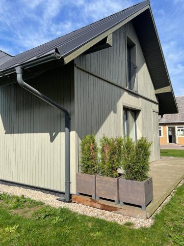 a house with a planter on the side of it at Private Trakai Historical Centre Karaim Two Floor Apartment in Trakai