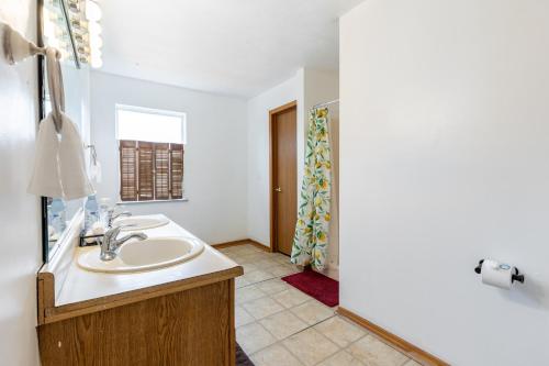 a bathroom with a sink and a mirror at Cozy 3BR Indy Home: Pets, Parking, Family-Ready in Indianapolis