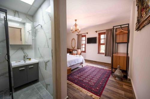 a bathroom with a bed and a shower and a sink at Lionas Hotel Kaleici in Antalya