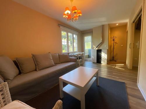 un soggiorno con un divano e un tavolo di La Puerta del Valle a Villafranca del Bierzo