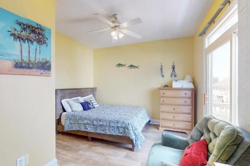a bedroom with a bed and a ceiling fan at Escape to Ocean Isle in Ocean Isle Beach