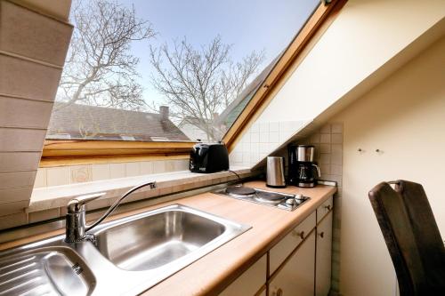 a kitchen with a sink and a window at Haus Frier in Helgoland