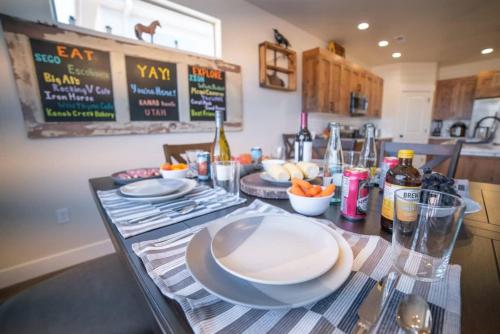 a kitchen with a table with plates on it at 3x3 Sanctuary at Kanab - New West Properties in Kanab