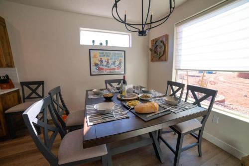 a dining room table and chairs with food on it at 3x3 Sanctuary at Kanab - New West Properties in Kanab