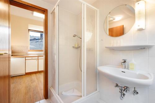 a bathroom with a sink and a shower at Haus Frier in Helgoland