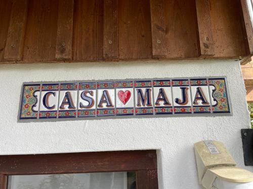 a sign for a casa mala on the side of a building at Ferienhaus Casa Maja in Bad Camberg