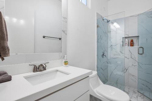a white bathroom with a sink and a shower at Casa Granito 20 - Playa Arcangel in Rosarito