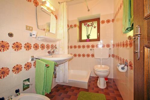 a bathroom with a sink and a toilet and a mirror at Pirchnerhof in Longomoso