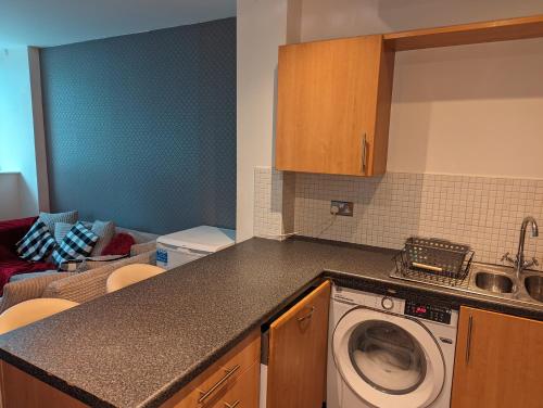 a kitchen with a washing machine in a kitchen at The Pinnacle 4/5 in Glasgow