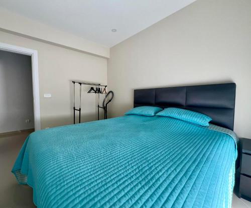 a bedroom with a large blue bed with blue pillows at Danver Apartment in Bar