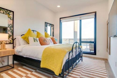 a bedroom with a bed and a large window at Stylish downtown condo w/ pool & parking in Nashville