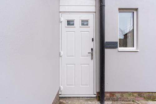 a white door with a window on a white wall at Free Parking Ideal for solo business travellers in Ilkeston