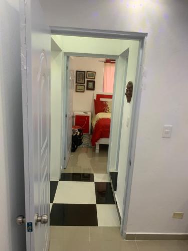 a hallway leading to a bedroom with a bed at Luxury Room SC in San Cristóbal