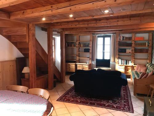 a living room with a couch and a table at Atmospheric, original stone chalet in Meribel in Les Allues