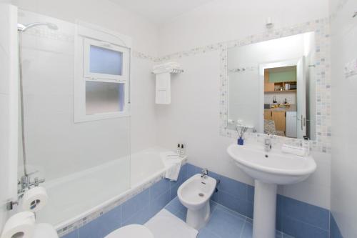 un bagno blu e bianco con lavandino e servizi igienici di Vive Costa Azul a Benalmádena