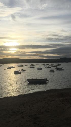 a group of boats in the water at sunset at Komorebi Healing House in Dawlish