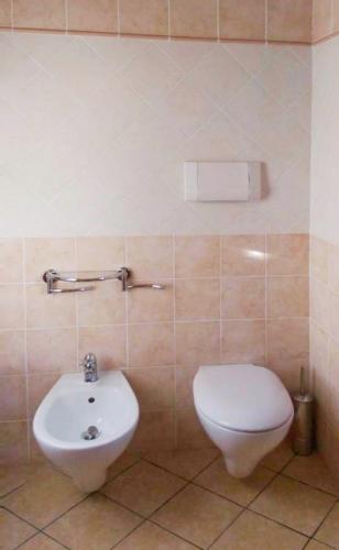 a bathroom with a toilet and a sink at Relax Home in La Caletta
