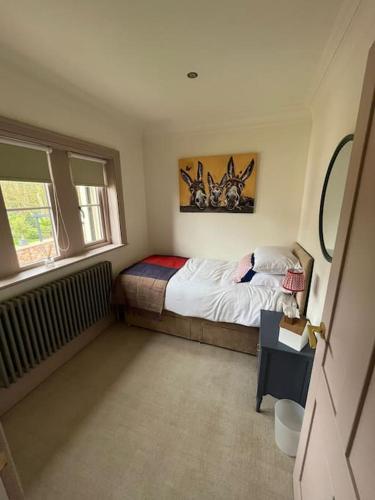 a small bedroom with a bed and a window at Cosy hideaway in leafy Lytham in Lytham St Annes