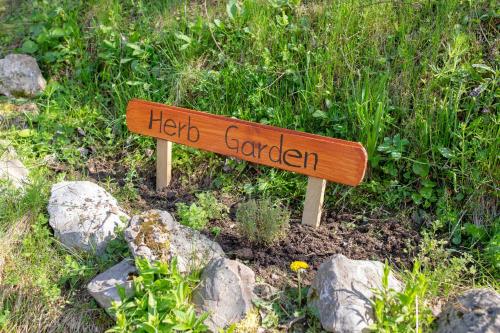 a sign that says hog garden in a field of rocks at Quiet family house Butterfly place in Dob