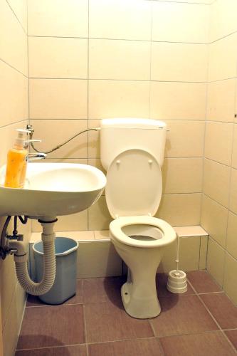 a bathroom with a toilet and a sink at Hostel Room in Banja Luka