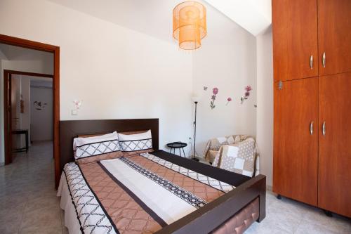 a bedroom with a large bed and a dresser at Natural Quiet Accommodation in Kallithea Rhodes