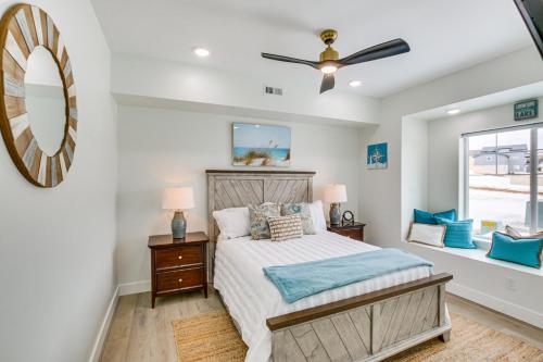a bedroom with a bed and a ceiling fan at Modern and Spacious Garden City Home with Pool Access! in Garden City