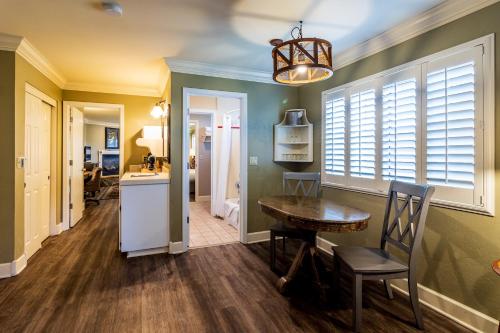 a kitchen with a table and a dining room at Cambria Pines Lodge in Cambria