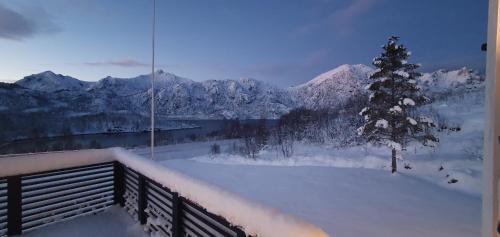 a view of a snow covered mountain range from a balcony at JULIA in Myre