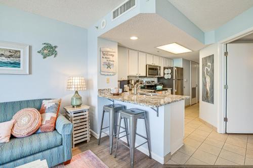 a living room with a couch and a kitchen at Steps to Boardwalk Condo with Pool in Myrtle Beach in Myrtle Beach