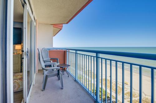 a balcony with a chair and a view of the ocean at Steps to Boardwalk Condo with Pool in Myrtle Beach in Myrtle Beach