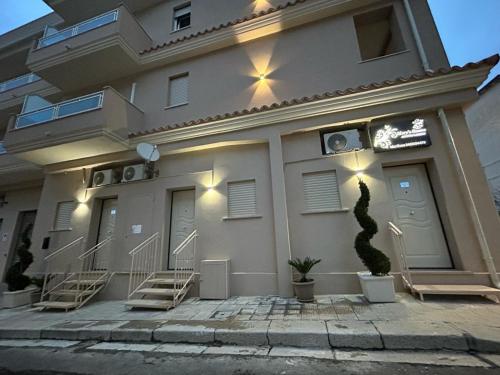 a building with stairs in front of it with lights at Mary's rooms in Parghelia