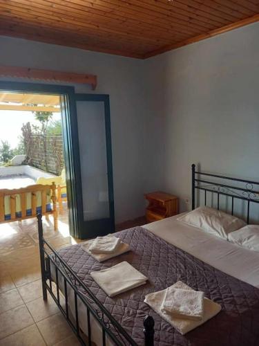 a bedroom with a bed with two towels on it at Villa Savvas in Paralia Vrachou