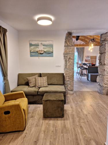 a living room with a couch and a table at Vila Ulika in Malinska