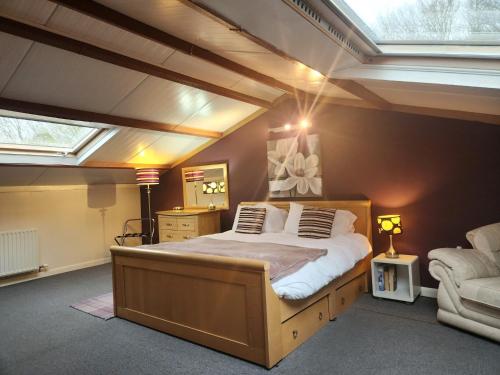 a bedroom with a large bed with a skylight at 3 Bed in Holmrook SZ272 in Holmrook