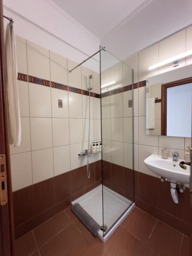 a bathroom with a shower and a sink at Eros Apartment Superb View in Gythio