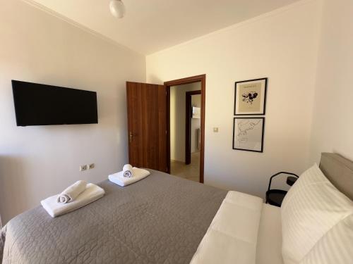 a bedroom with a bed with two towels at Eros Apartment Superb View in Gythio