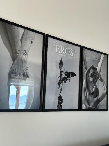 a group of four pictures hanging on a wall at Eros Apartment Superb View in Gythio