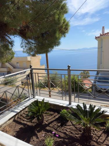 a balcony with a fence and a view of the ocean at Eros Apartment Superb View in Gythio