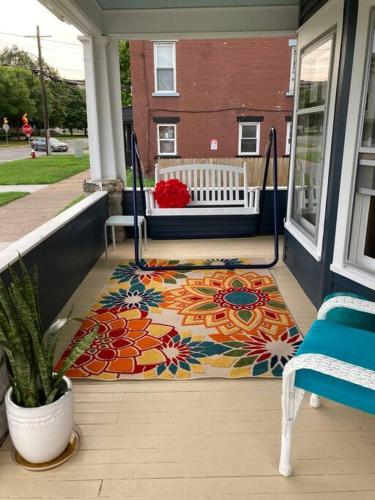 a porch with a colorful rug on a house at Fiesinger House - Private 3-bd Unit in Historic Home, Downtown Sandusky in Sandusky