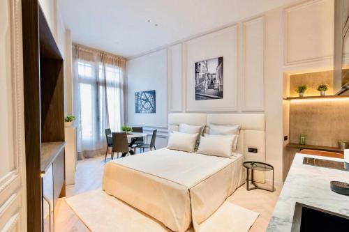 a living room with a bed and a table at SAINT- PAUL - LUXURY APARTMENT IN HOTEL DE VILLE in Paris