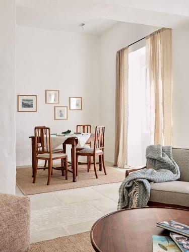 a living room with a table and chairs at Solar do Bisavô in Bordeira