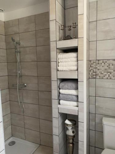 a bathroom with a shower and some towels at la maison bel air in Limoux