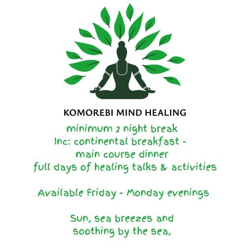 a woman sitting in a yoga pose with a plant at Komorebi Healing House in Dawlish